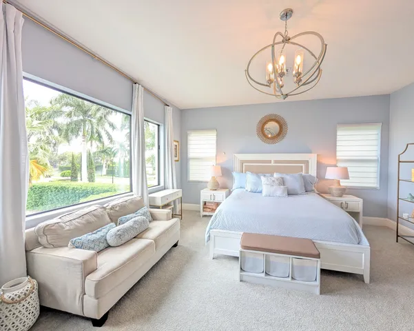 a bathroom with a granite countertop sink a toilet a mirror and shower