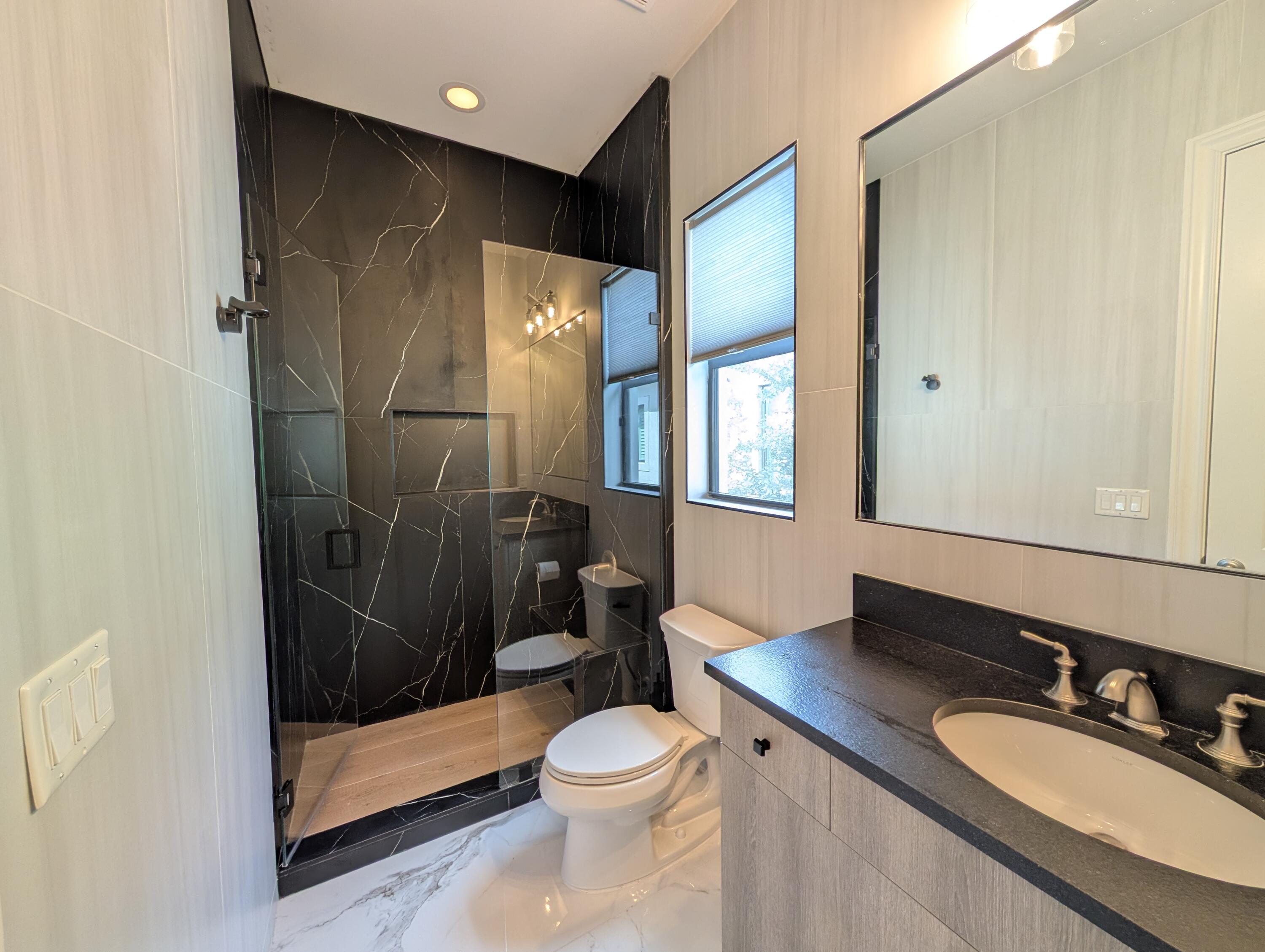 7095 Northwest 27th Avenue Boca Raton, FL 33496 - Photo 25 of 51 a bathroom with a sink a toilet and shower