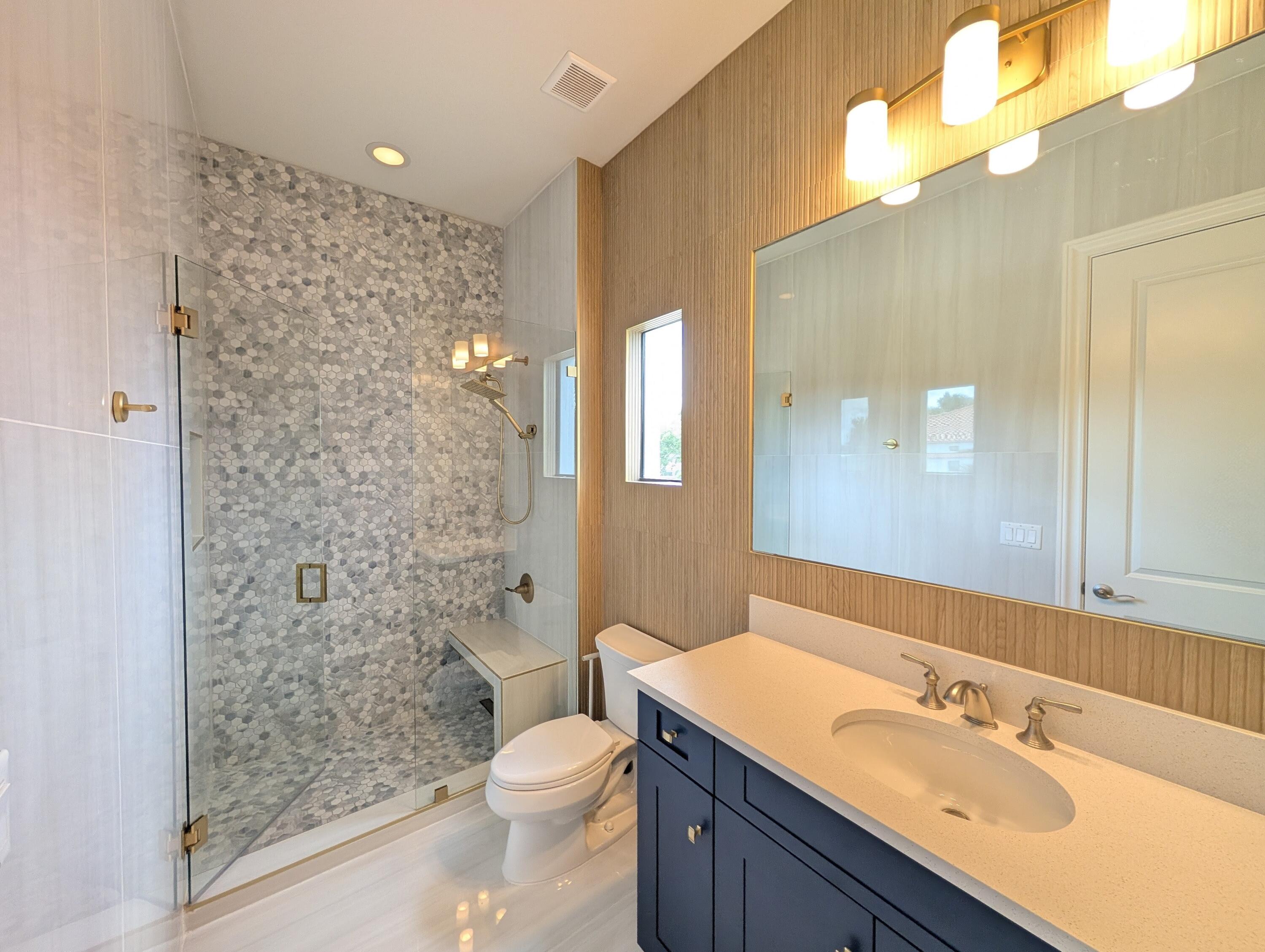 7095 Northwest 27th Avenue Boca Raton, FL 33496 - Photo 26 of 51 a bathroom with a sink a toilet a shower and a mirror