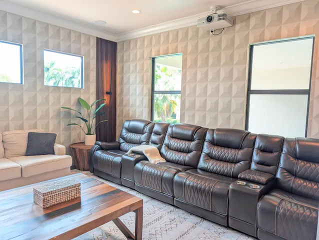 a view of a room with pool table and windows