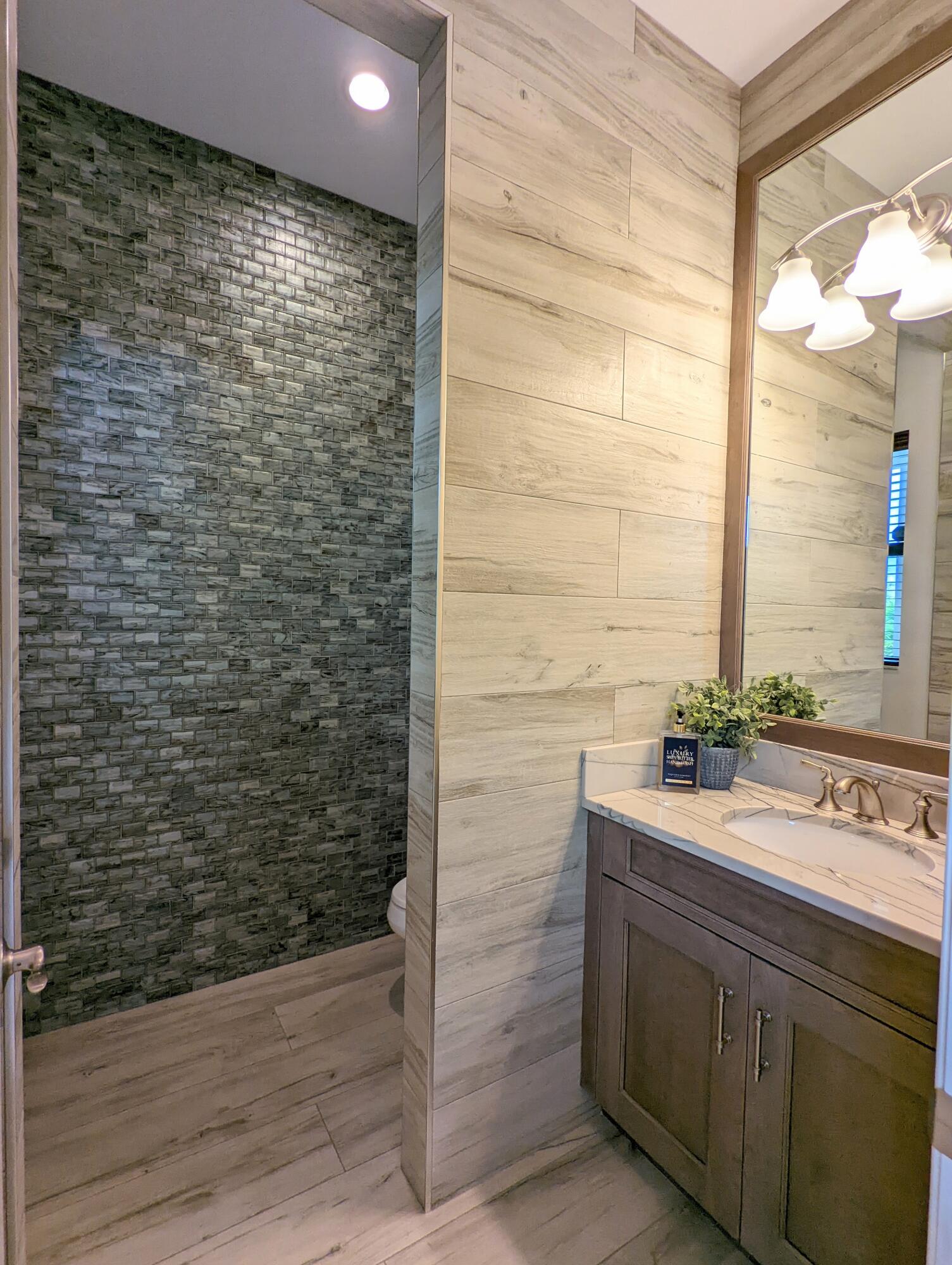 7095 Northwest 27th Avenue Boca Raton, FL 33496 - Photo 38 of 51 a bathroom with a sink and a mirror