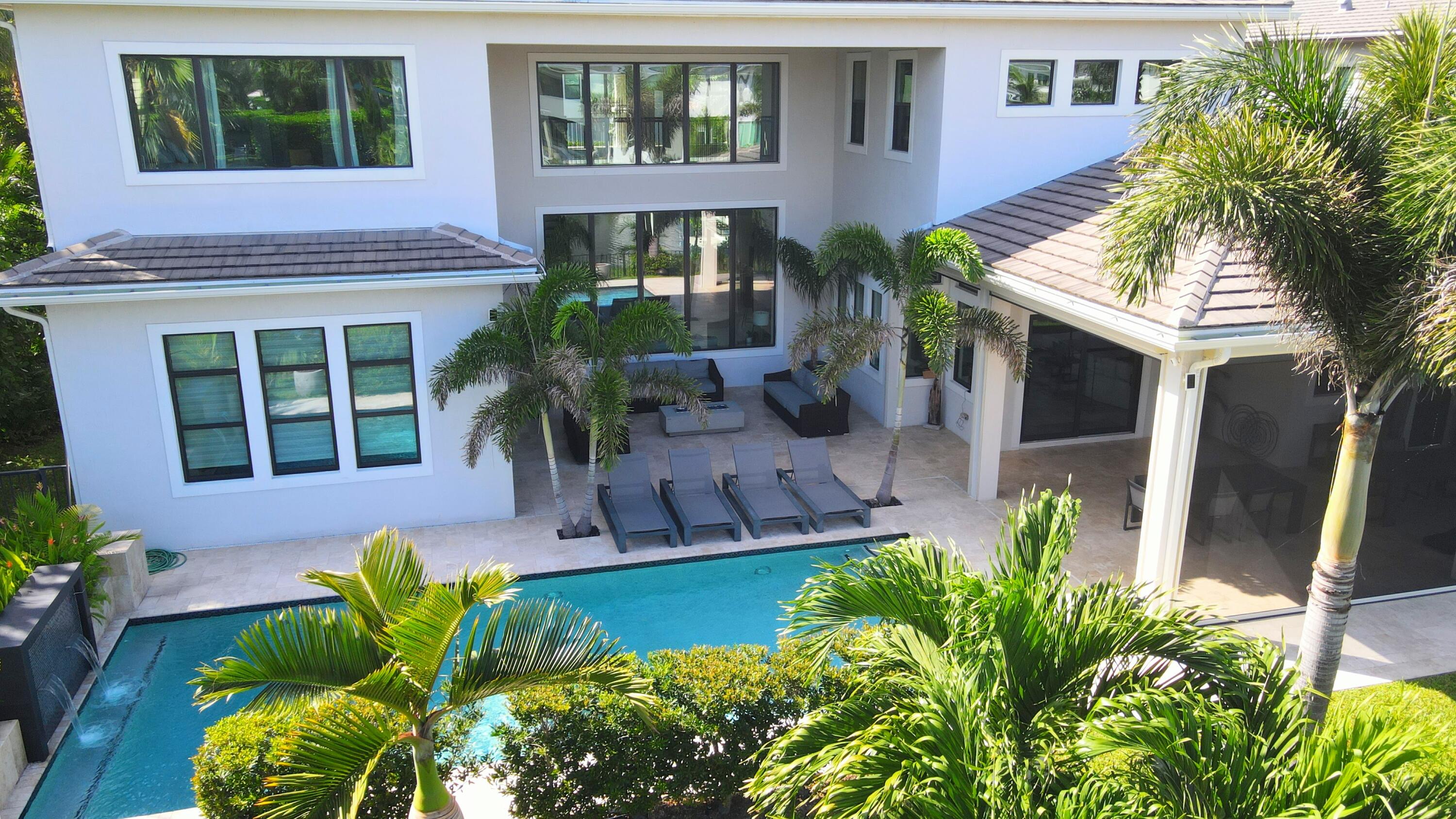 7095 Northwest 27th Avenue Boca Raton, FL 33496 - Photo 42 of 51 a front view of a house with garden