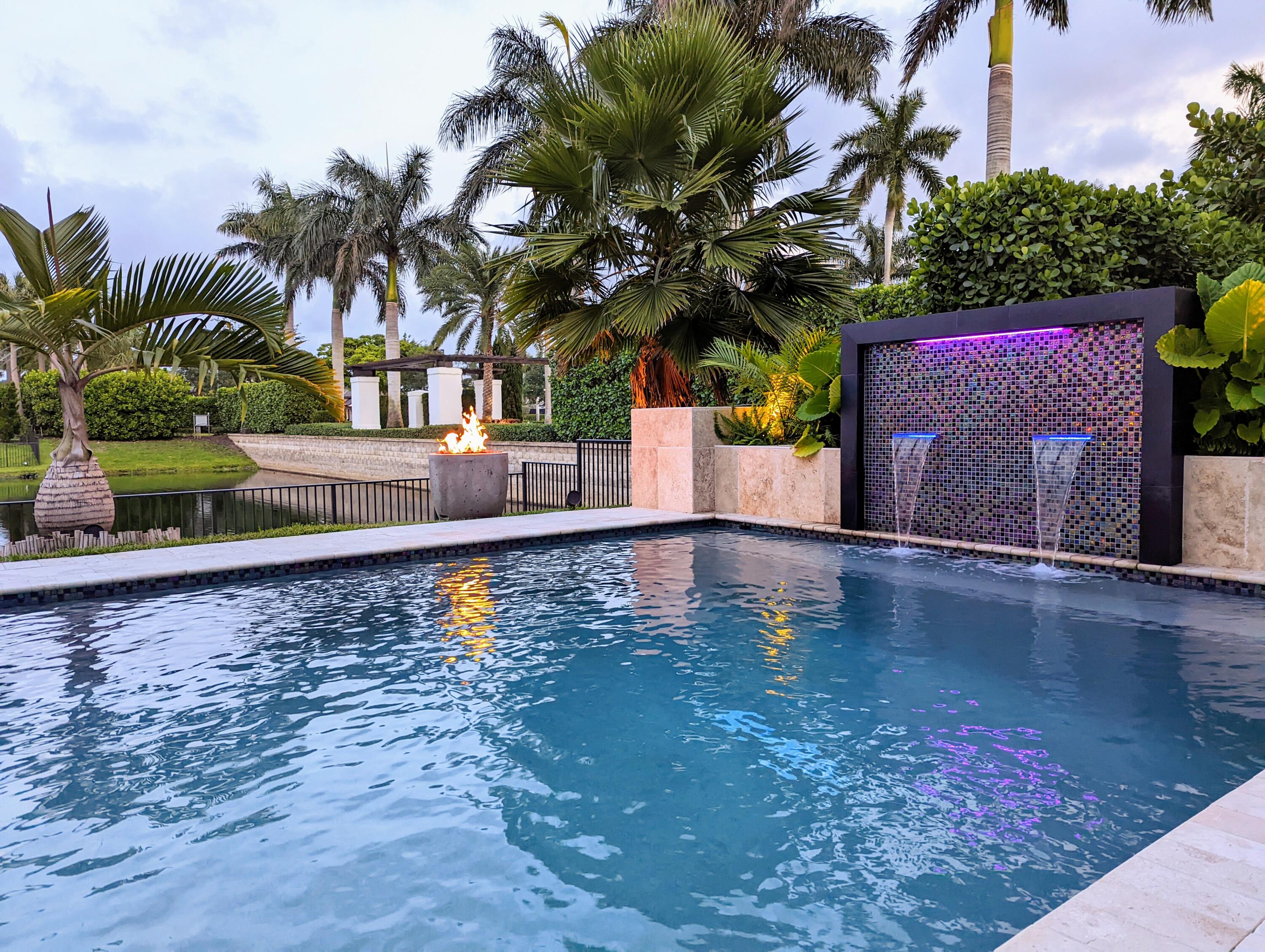 7095 Northwest 27th Avenue Boca Raton, FL 33496 - Photo 44 of 51 a front view of a house with yard and swimming pool