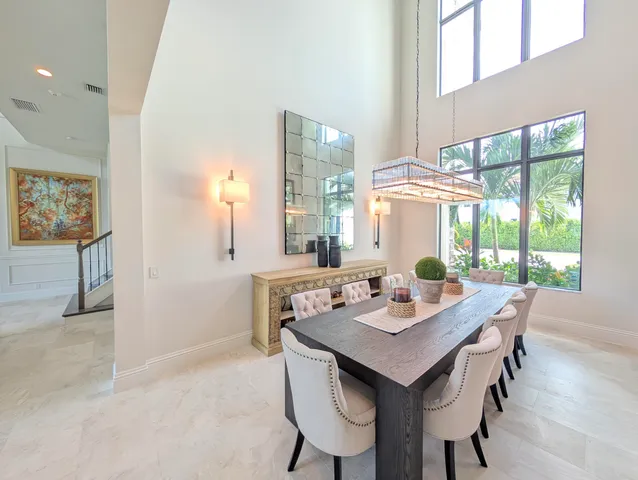 a view of a dining room with a table and chairs