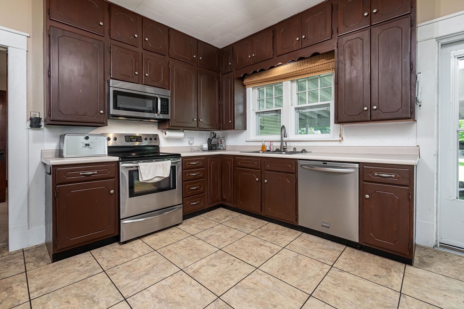 505 California Street Carterville, IL 62918 - Photo 14 of 23 a kitchen with stainless steel appliances granite countertop a stove top oven a sink dishwasher and a refrigerator