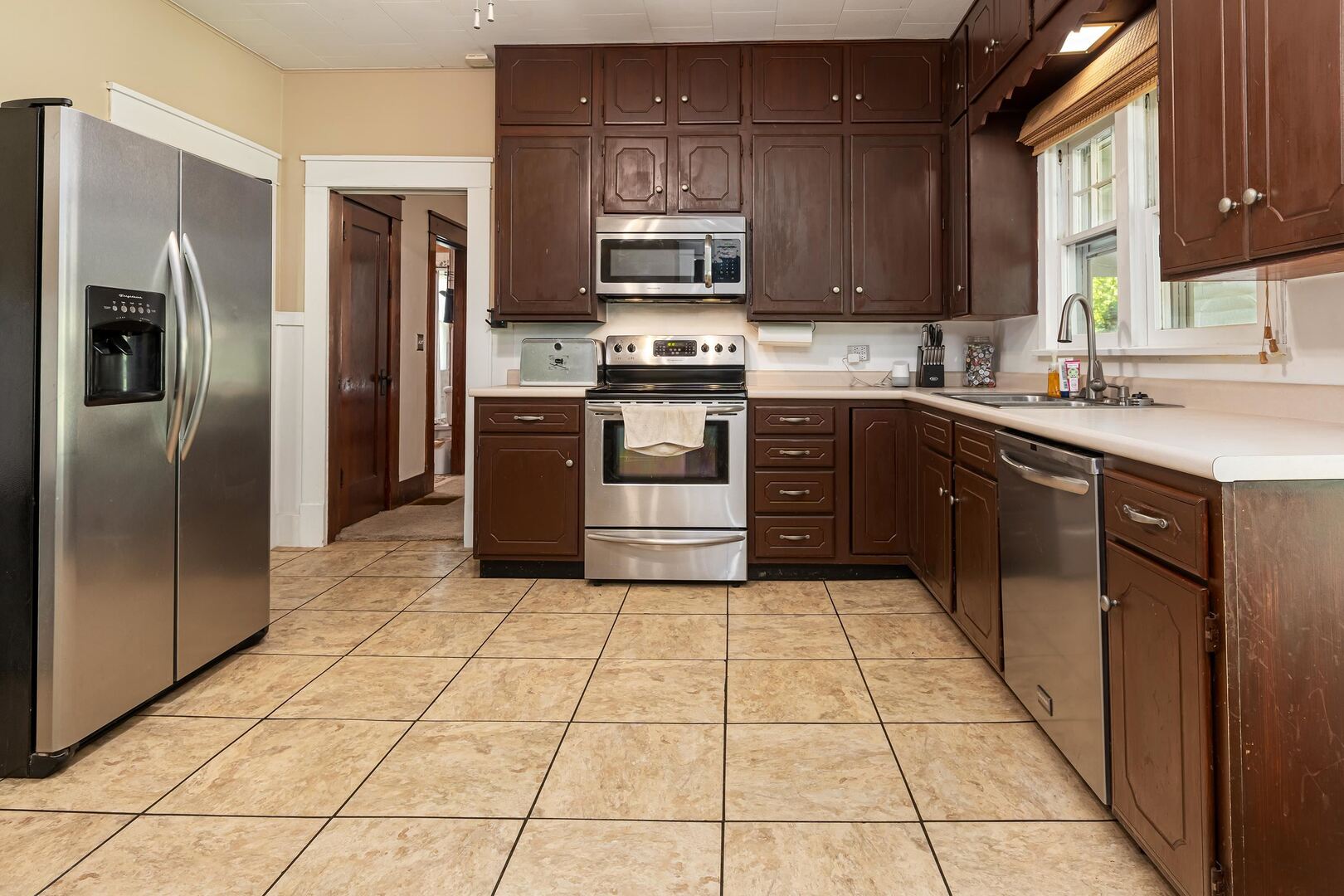 505 California Street Carterville, IL 62918 - Photo 15 of 23 a kitchen with stainless steel appliances granite countertop a stove top oven a refrigerator and a sink