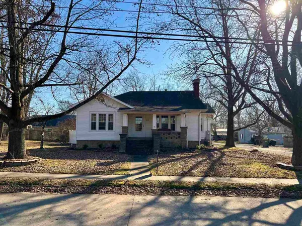 a view of a house with a yard covered in snow
