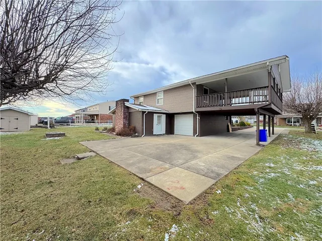 a view of a house with a yard and garage