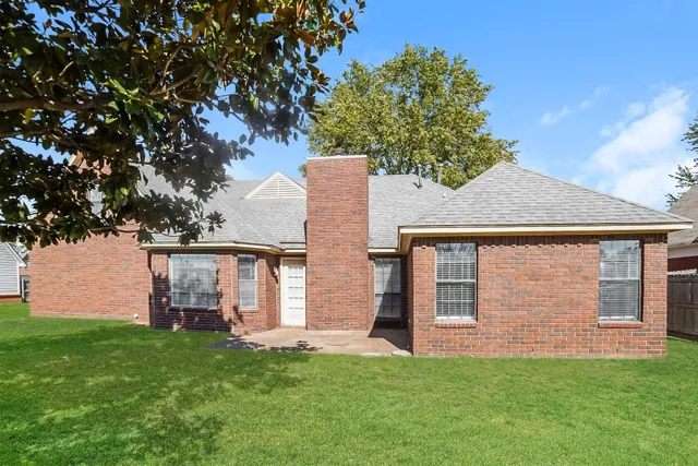 a front view of house with a garden
