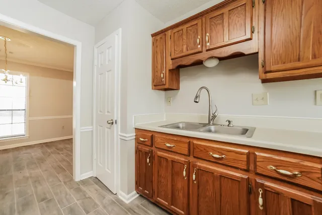 a kitchen with stainless steel appliances granite countertop a sink dishwasher and cabinets with wooden floor