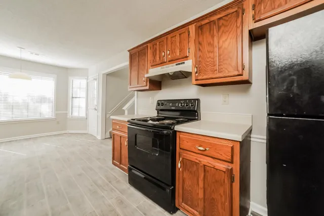 a kitchen with stainless steel appliances granite countertop a stove a refrigerator and a microwave