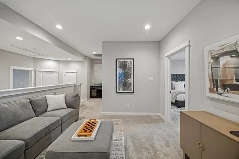 a living room with furniture and painting on the wall