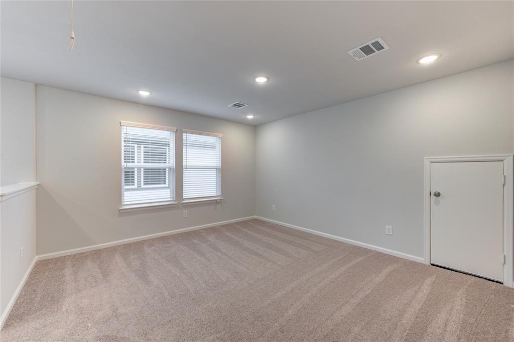 94 Valiant Ridge Trail Magnolia, TX 77354 - Photo 8 of 13 a view of an empty room with a window