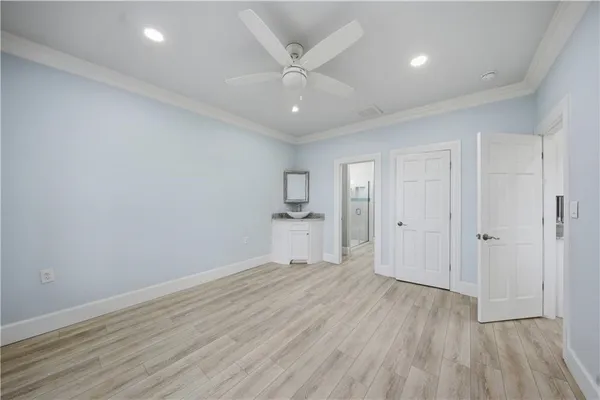 a view of storage and utility room with wooden floor