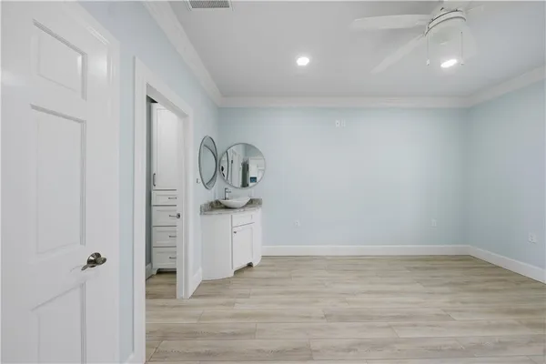 a big room with wooden floor and white doors