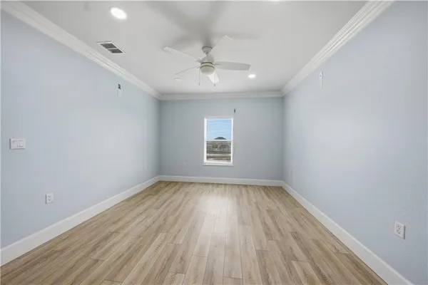 a view of an empty room and window and wooden floor