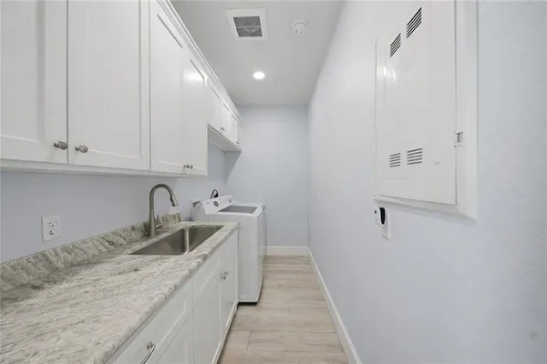 a bathroom with a granite countertop toilet and a sink