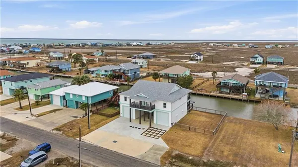 an aerial view of a house with a ocean view