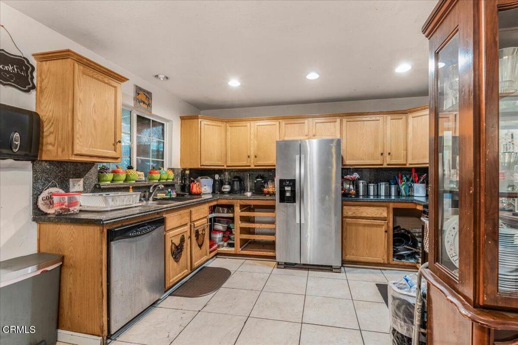 1211 West Robert Avenue Oxnard, CA 93030 - Photo 3 of 14 a kitchen with stainless steel appliances granite countertop a refrigerator and a stove