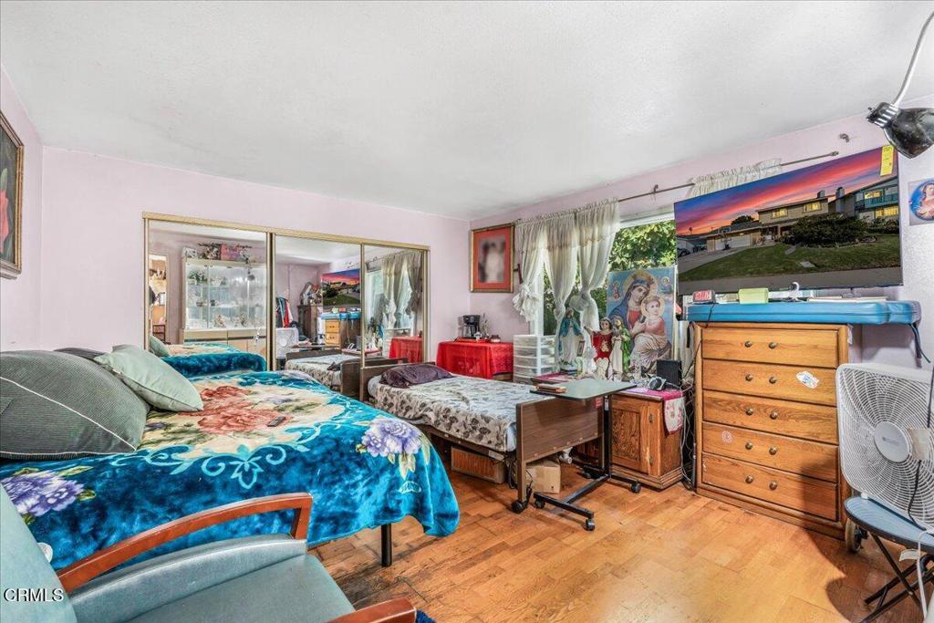 1211 West Robert Avenue Oxnard, CA 93030 - Photo 5 of 14 a bed room with furniture and a flat screen tv