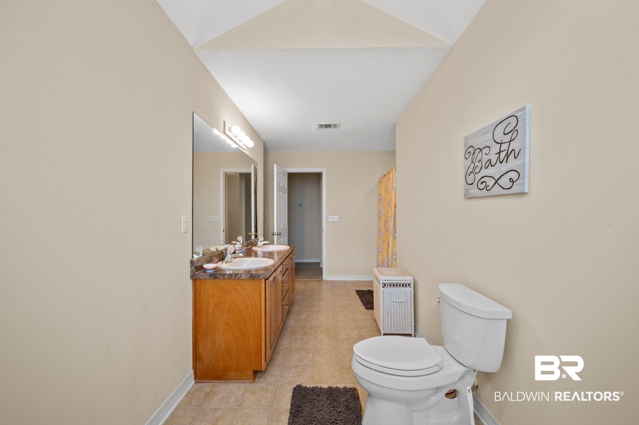 9539 Lakeview Road Bay Minette, AL 36507 - Photo 26 of 45 Bathroom with tile patterned flooring, vanity, toilet, and vaulted ceiling