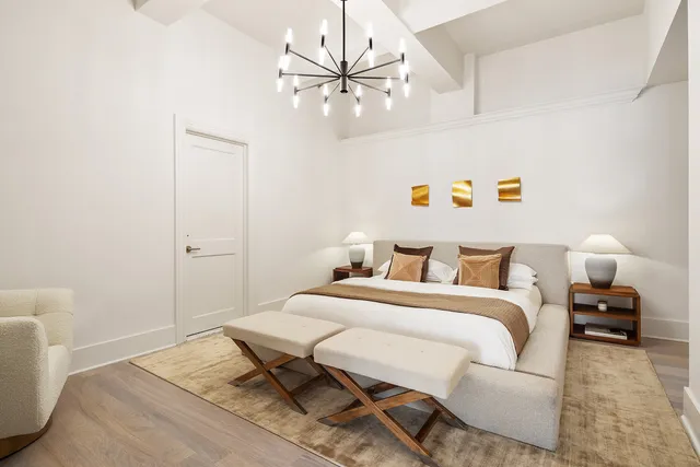 a bedroom with a bed and a couch