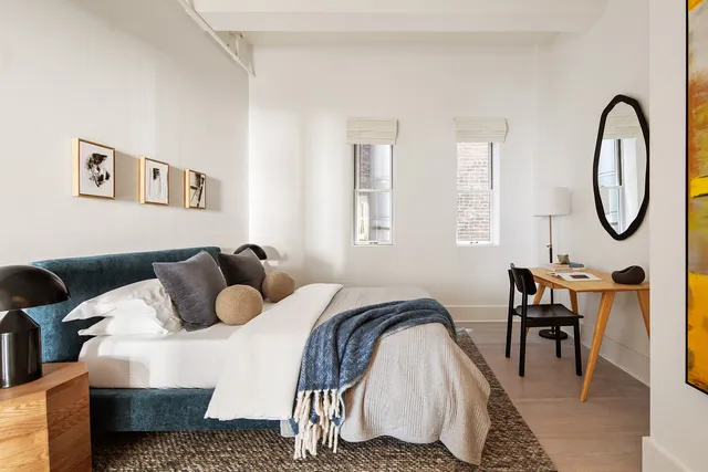 a bedroom with furniture and a window