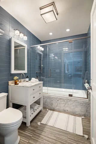 a bathroom with a sink mirror toilet and bathtub