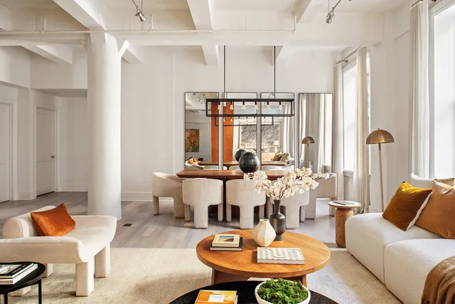 a living room with furniture a rug and a chandelier