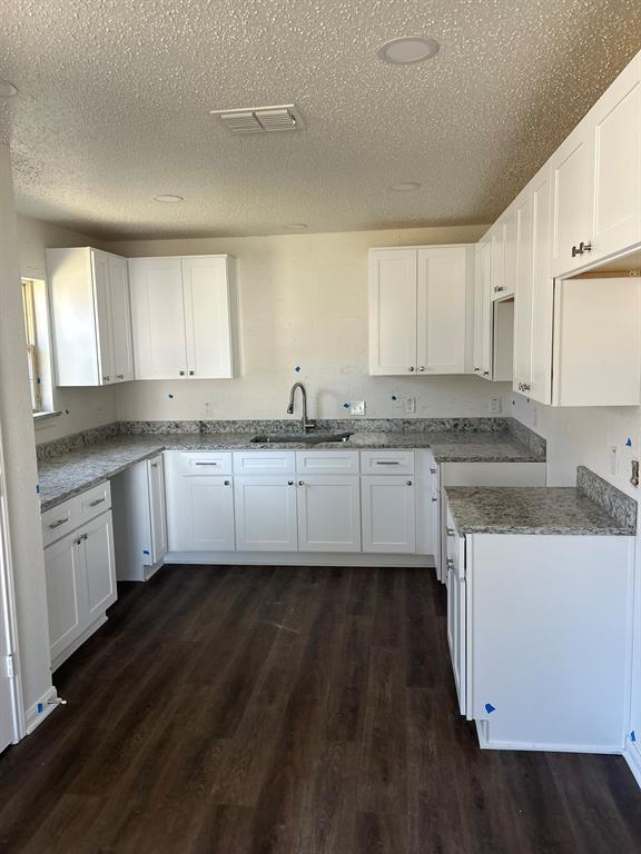 4720 Burma Road Dallas, TX 75216 - Photo 1 of 13 a kitchen with granite countertop a sink a stove cabinets and counter space
