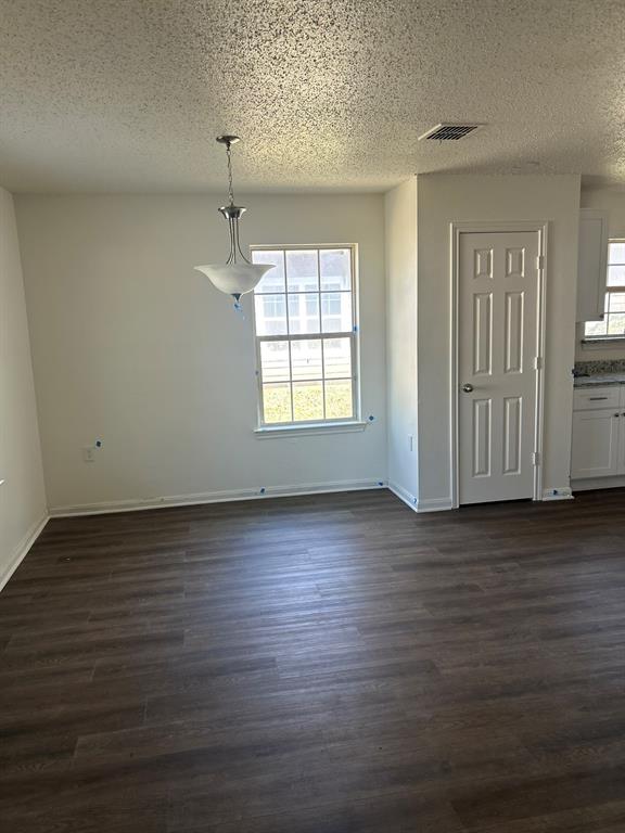 4720 Burma Road Dallas, TX 75216 - Photo 3 of 13 an empty room with wooden floor and windows