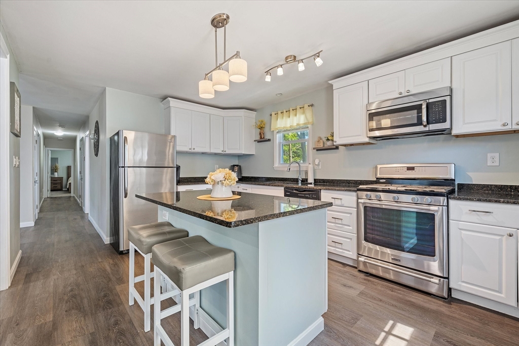 14 Grosvenor Street Ayer, MA 01432 - Photo 11 of 30 a kitchen with stainless steel appliances granite countertop a sink stove and refrigerator