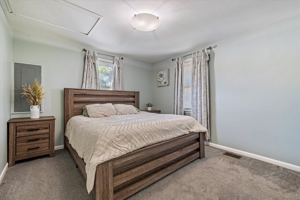 14 Grosvenor Street Ayer, MA 01432 - Photo 14 of 30 a bed sitting in a bedroom next to a window and a chandelier