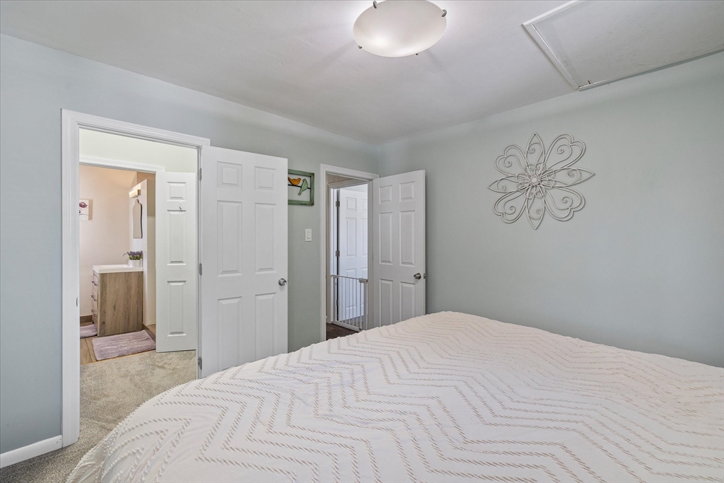 14 Grosvenor Street Ayer, MA 01432 - Photo 15 of 30 a bedroom with a large bed and a chandelier