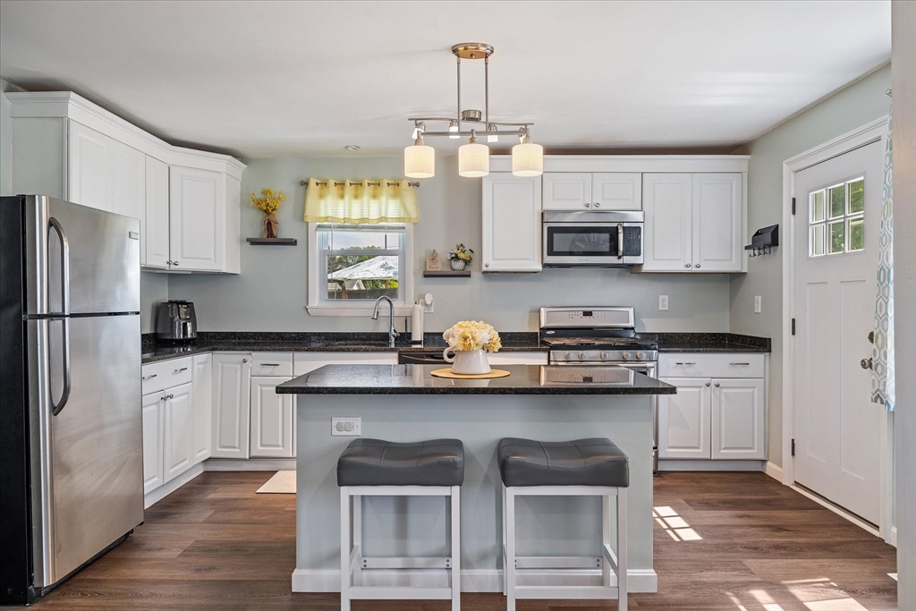 14 Grosvenor Street Ayer, MA 01432 - Photo 9 of 30 a kitchen with stainless steel appliances granite countertop a stove refrigerator sink and cabinets