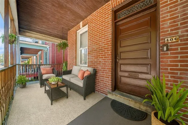 a balcony with furniture and a potted plant