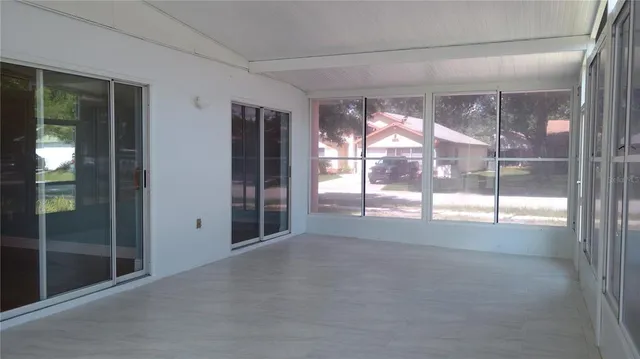 a view of empty room with floor to ceiling window