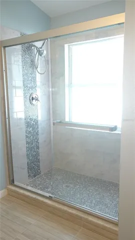 a bathroom with a glass shower door