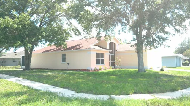 a front view of house with yard and trees