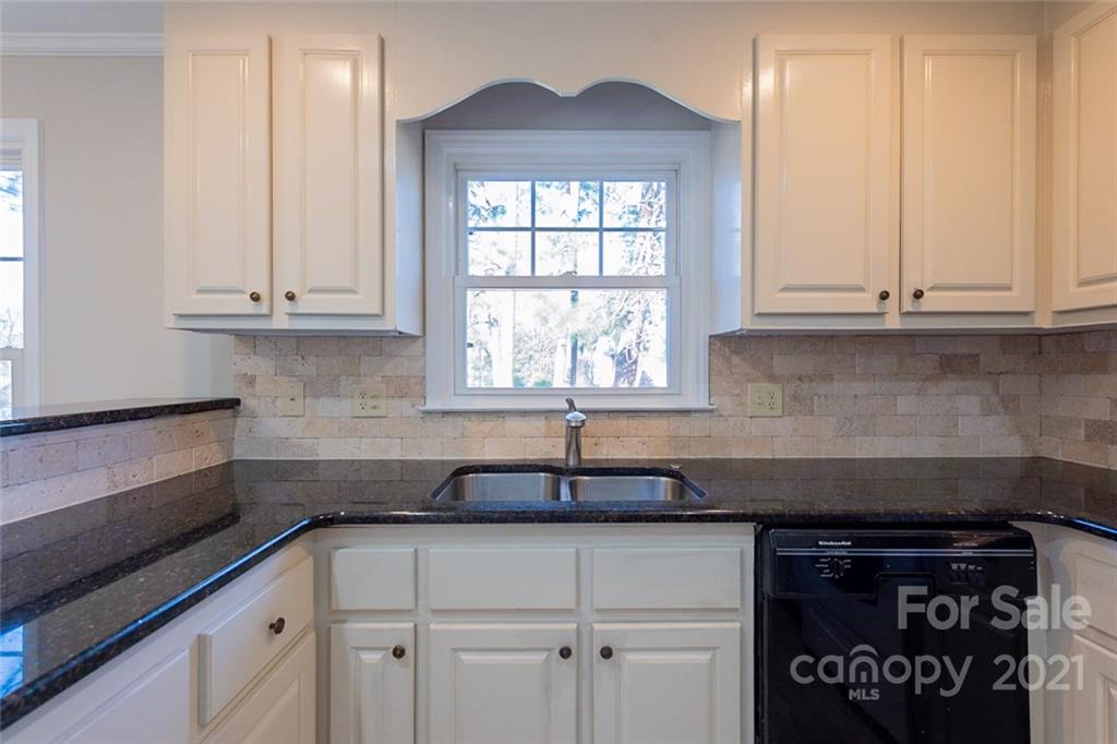 1593 Brook Drive Fort Mill, SC 29708 - Photo 8 of 18 a kitchen with granite countertop white cabinets and a window