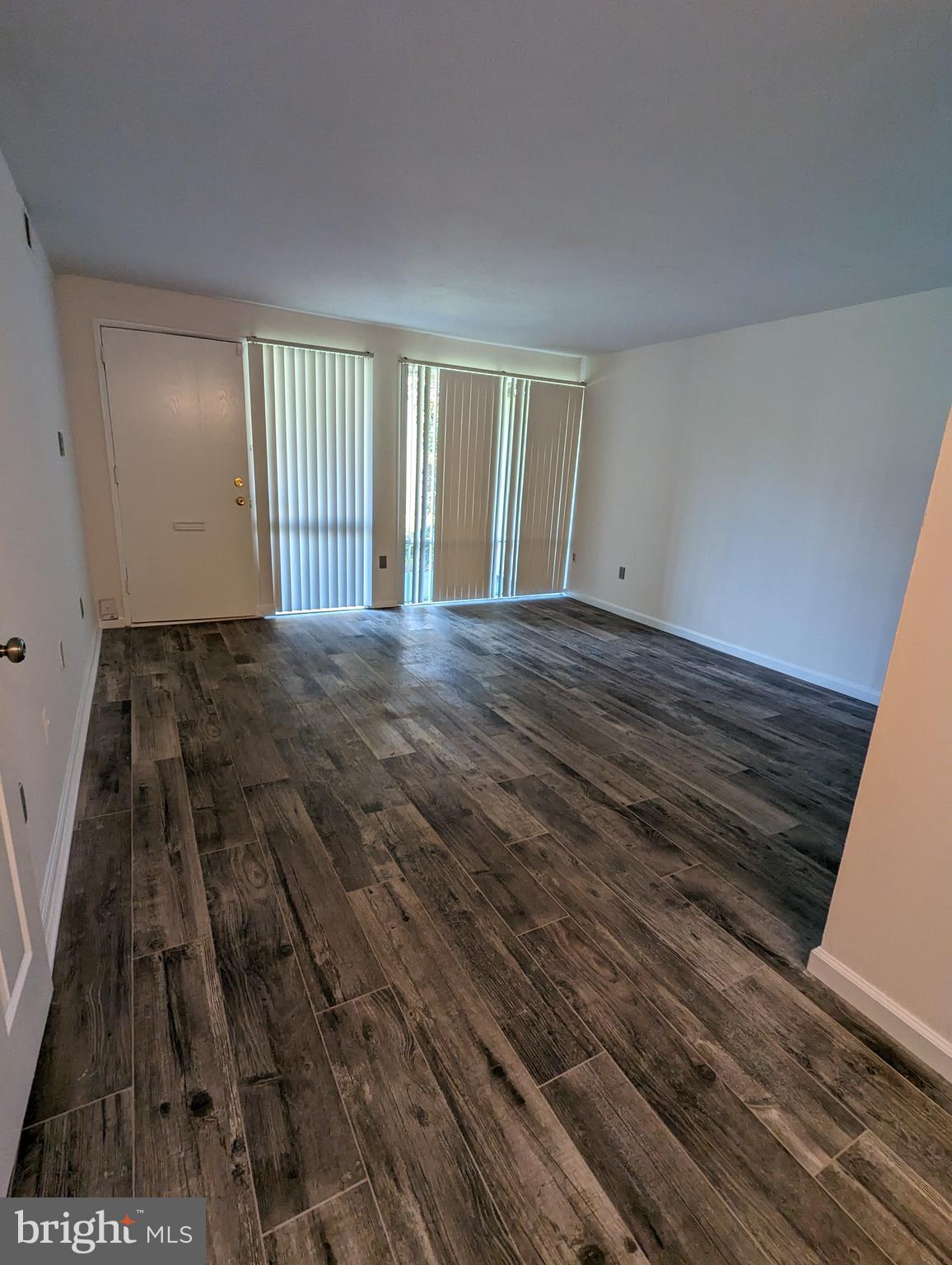 7252 Donnell Place, Unit A2 District Heights, MD 20747 - Photo 3 of 12 a view of an empty room and wooden floor