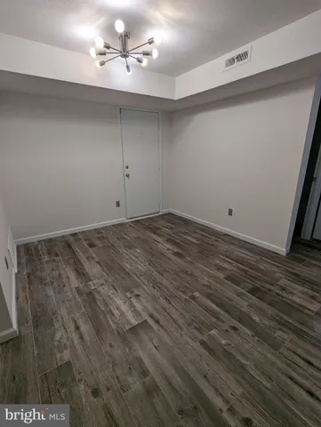 a view of a room with wooden floor