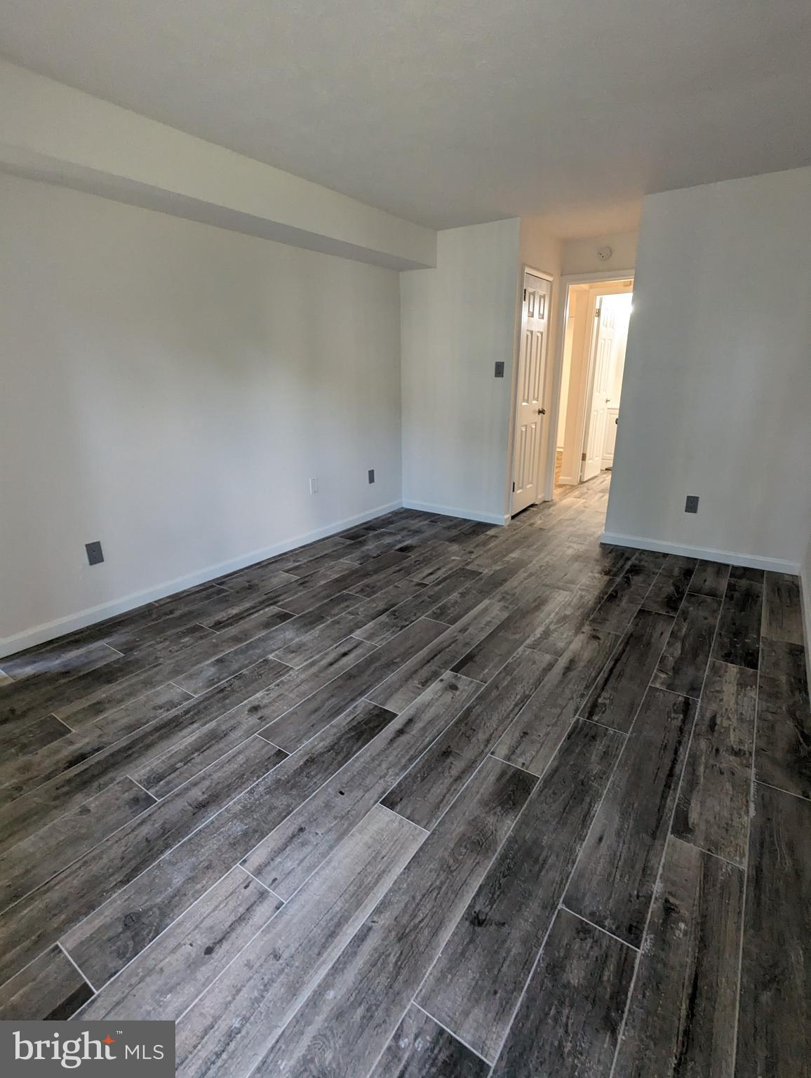 7252 Donnell Place, Unit A2 District Heights, MD 20747 - Photo 10 of 12 a view of a room with wooden floor