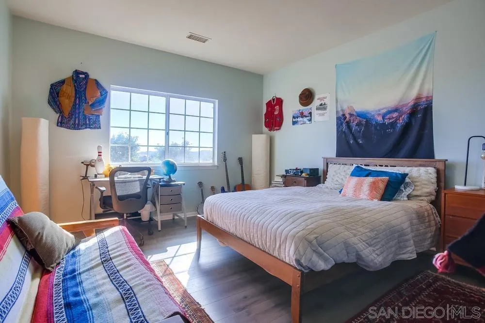 39221 Daily Road Fallbrook, CA 92028 - Photo 16 of 26 a bedroom with bed and a large mirror