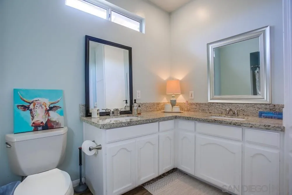39221 Daily Road Fallbrook, CA 92028 - Photo 17 of 26 a bathroom with a granite countertop toilet sink and mirror