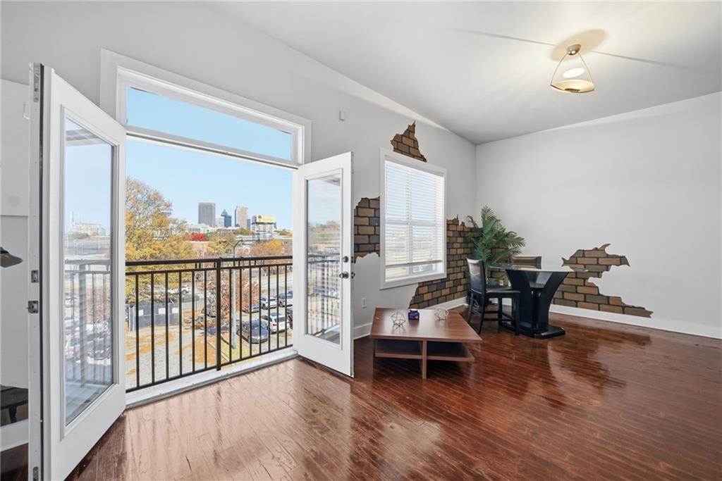 a living room with furniture and wooden floor