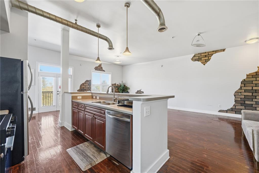 502 Pryor Street Southwest, Unit 328 Atlanta, GA 30312 - Photo 13 of 46 a kitchen with stainless steel appliances granite countertop a stove and a refrigerator