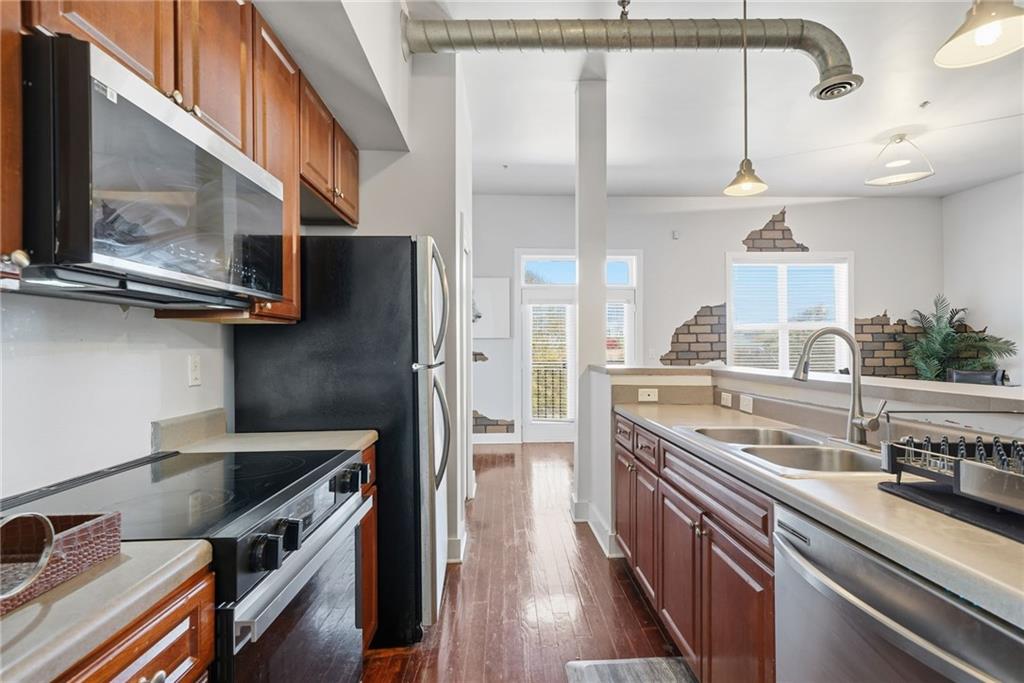 502 Pryor Street Southwest, Unit 328 Atlanta, GA 30312 - Photo 14 of 46 a kitchen with stainless steel appliances granite countertop a sink a stove and a refrigerator