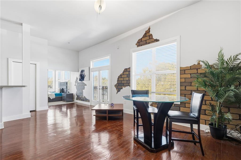 502 Pryor Street Southwest, Unit 328 Atlanta, GA 30312 - Photo 17 of 46 a view of a dining room with furniture window and wooden floor