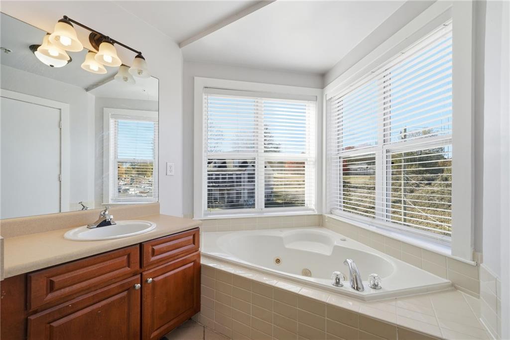 502 Pryor Street Southwest, Unit 328 Atlanta, GA 30312 - Photo 19 of 46 a bathroom with a bathtub a sink and a window